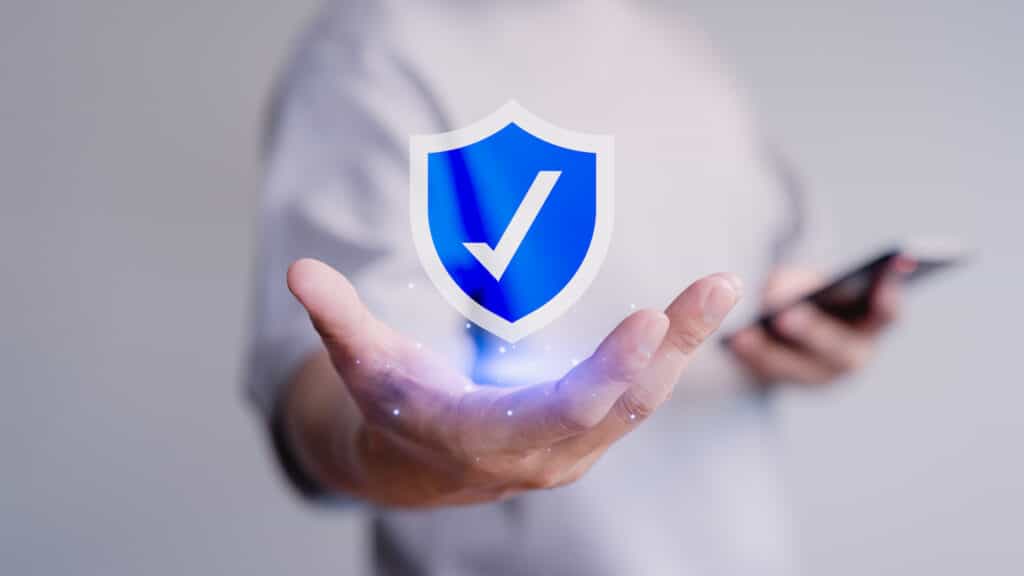 Image man holding shield with checkmark.